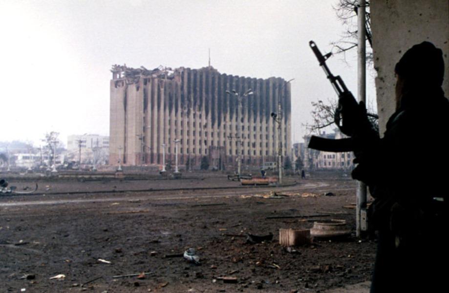 Chechen Fighter Watching Over Burned out Parliament in Grozny, 1995