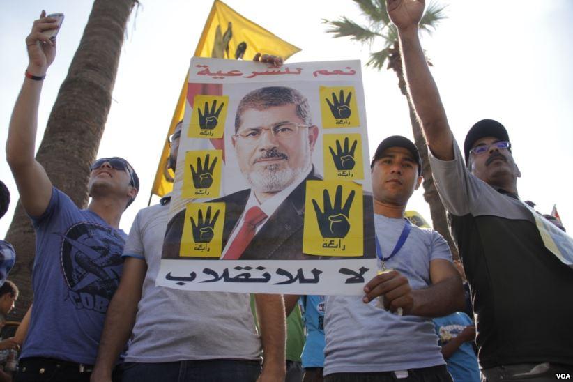 Protesters holding Morsi Poster, Cairo Egypt, September 2013