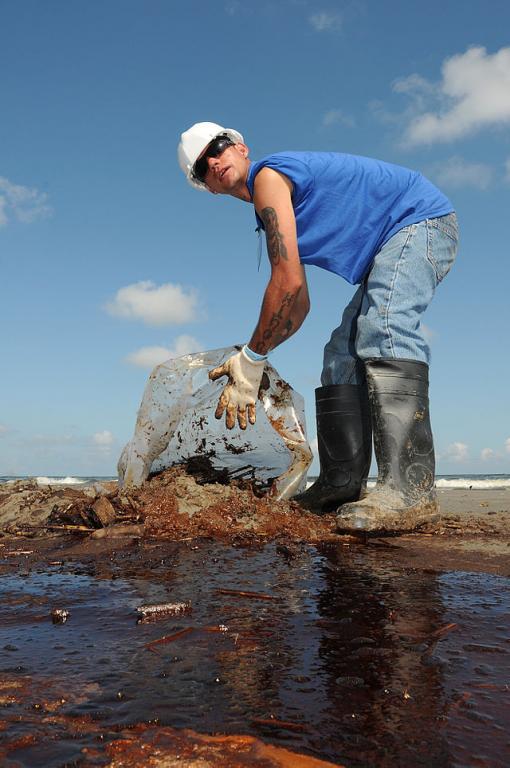 Worker Cleans Up Oily Waste Following Deepwater Horizon